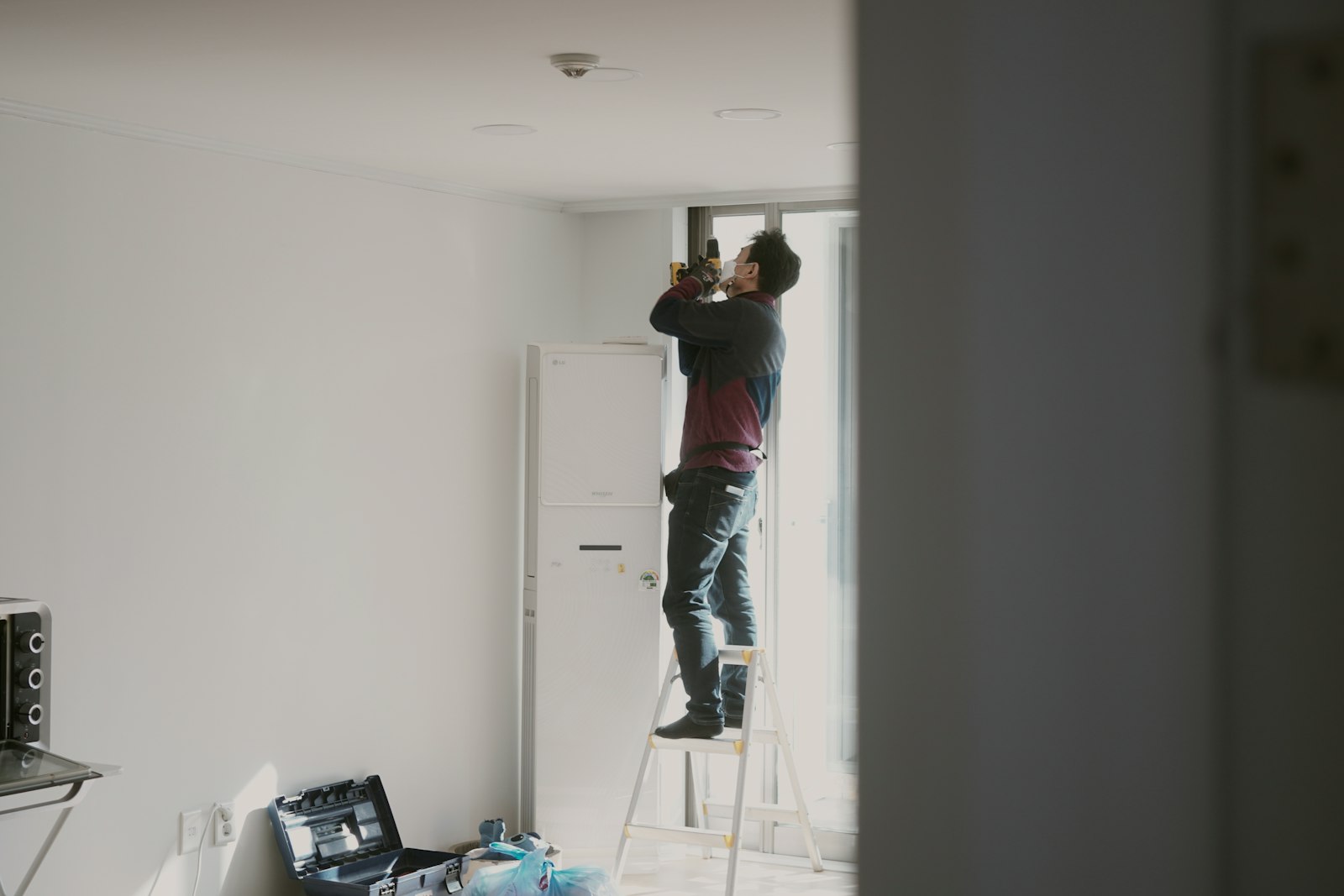 a handyman working on a ceiling