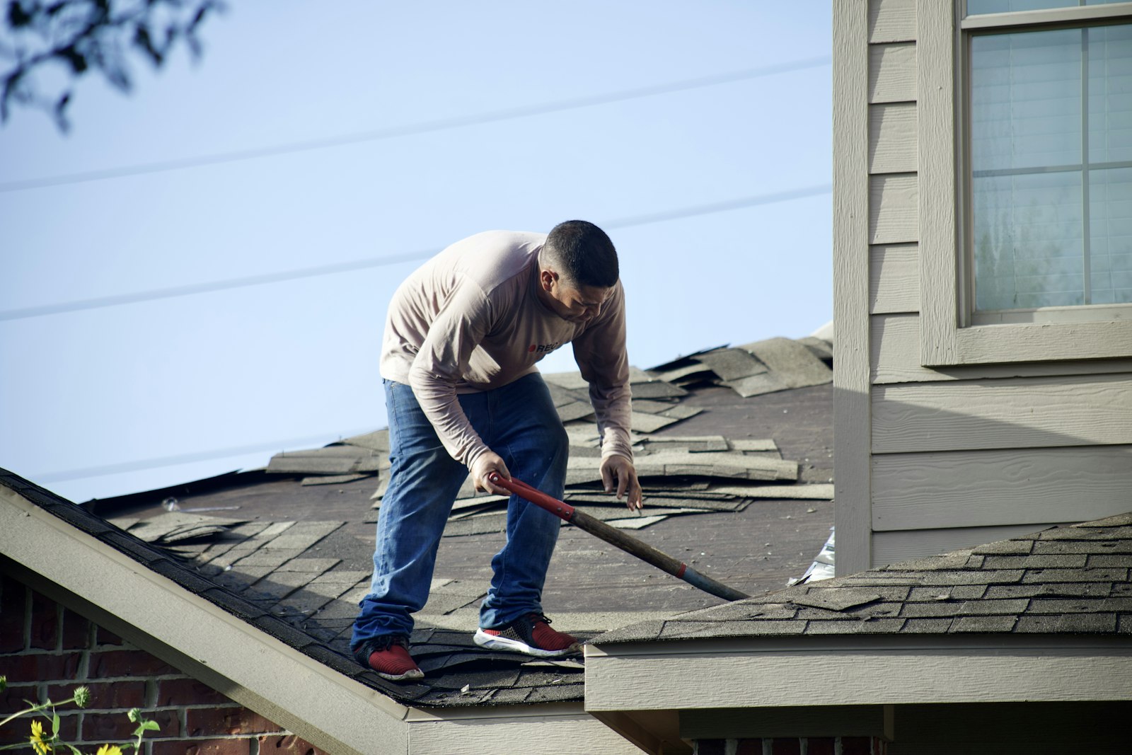 a roofer working on a house roof